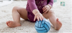 Baby playing with a toy ball